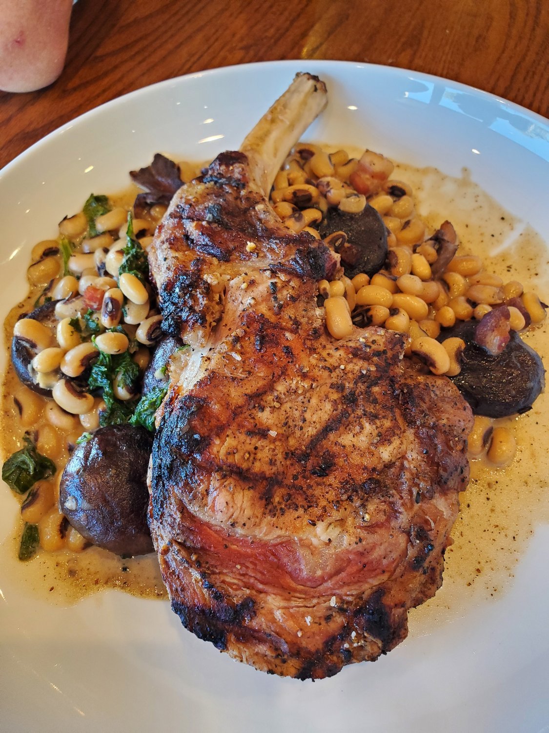 The grilled bone-in pork chop will make diners forget everything but the dish before them.